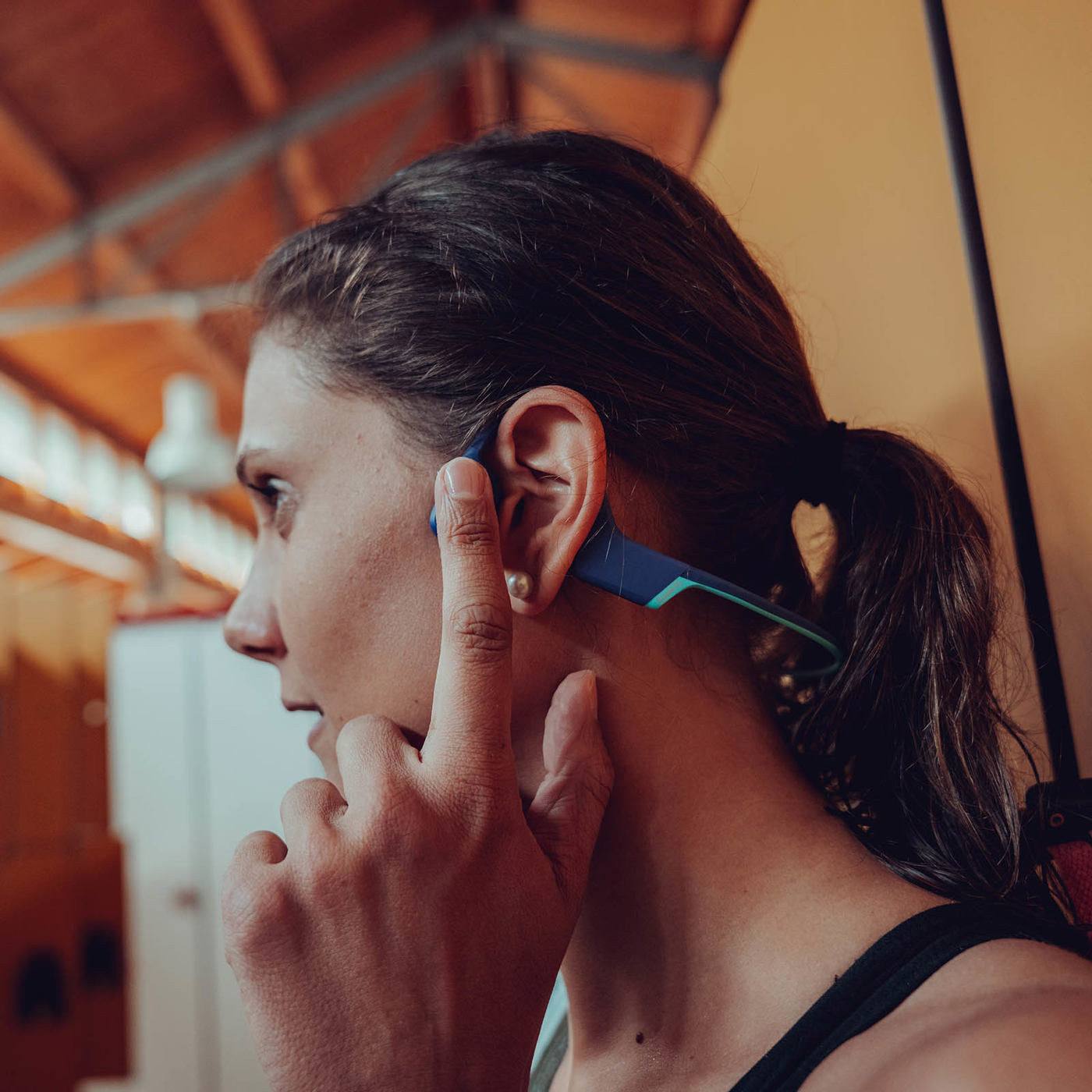 a woman holding her finger up to her ear
